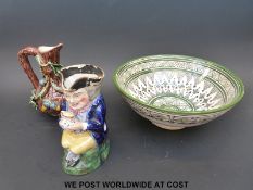 A bark effect jug with applied acorns, a Toby jug,