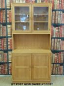 A pine dresser with glazed top and cupboard to base (W84 D42 H172cm)