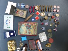 A quantity of military badges including Red Cross, Civil Defence, dog tags for 662040 C E Rhoden H,