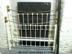 A brass and painted metal bed