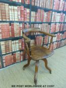 An early 20thC elm seated swivel/office chair