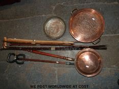 A quantity of copper items including a warming pan, Eastern dish, charger,