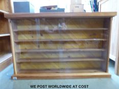 A pine display cabinet, previously used for models (W96 D15.