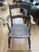A Victorian elm seated elbow chair