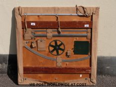 A military plotting board with attachments secured to rear including curves, map pins etc.