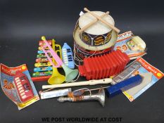 A collection of children's musical instruments to include tin drum, xylophone,