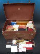 A vintage Neverdone case full of cigarette packets.