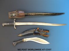 A WWI era bayonet in sheath and a kukri