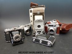 A box of seven vintage cameras including Zeiss folding and 35mm.