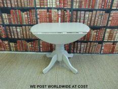 A contemporary painted kitchen table (diameter 90cm,