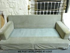 A three seat sofa with light green upholstery