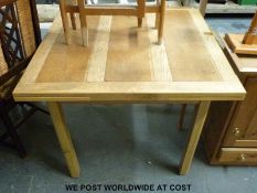 A light oak draw-leaf table