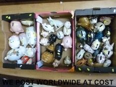 A large collection of ceramic pigs to include Wade, commemorative, money boxes 'piggy banks',