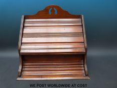 An Edwardian oak stationery box with fitted interior and fold over lid.