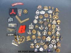 Over 50 military cap badges from WWI onwards, cloth examples,
