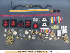 A quantity of British and German military badges to include German Anti Aircraft,