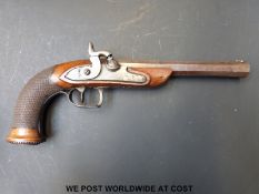 A 25 bore percussion hammer-action target pistol with chequered, carved and beaded grip,