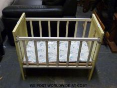 A small child's cot or doll's bed with cartoon characters to the end