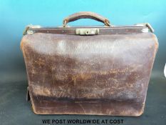 A leather midwife's / obstetrician's bag containing delivery forceps, autoclave / sterilising tray,