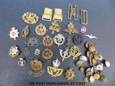 A selection of military buttons, badges, webbing, buckles etc, including early plastic examples,