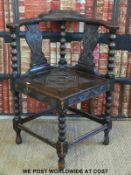 A carved oak corner chair