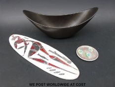 A long oval ceramic plaque in the manner of Picasso and two Poole pottery items