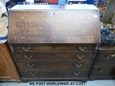 A Georgian oak bureau, the fall flap opening to reveal pigeon holes,