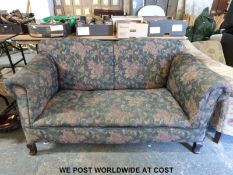 A two seat sofa with drop end