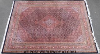 A large Bidjar carpet with an Arabic style design on blue ground (345 x 246cm)