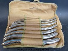 A canvas roll by William Bros London containing eight Hegar double ended surgical dilators,