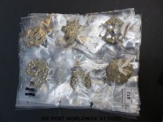 A collection of military badges including Tyneside Scottish Regiment, Bydand (Gordon Highlanders),