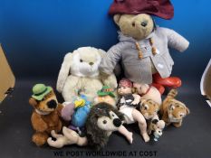 A collection of soft toys together with a bisque baby doll
