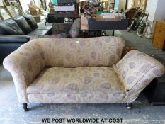 A drop arm two seat sofa