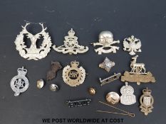 A quantity of cap badges and buttons including military and HM Prisons