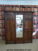 An oak three door wardrobe or compactum with drawers to interior (W190 D52 H207cm)