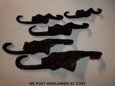 Five carved and graduated wise monkey hooks