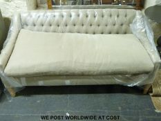 A two seat sofa with button back design