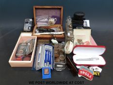 A quantity of collectables to include pens, coins, military badges, small toys, penny red stamp,