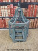 A painted bird cage and a wicker log basket