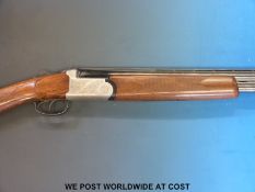 Lincoln 12 bore over and under shotgun with all over floral engraving, double trigger,