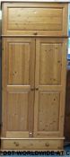 A pine wardrobe with cupboard above and drawer below (W95 D58 H219cm)