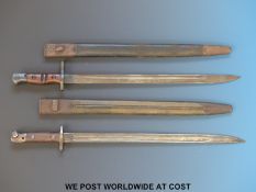 A Remington 1917 bayonet together with a Wilkinson example