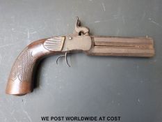 Double barrelled over and under percussion hammer action pocket pistol with carved and chequered