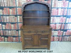 An oak dresser with Dutch style top and two drawers and cupboards to base (W111 D48 H180cm)