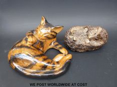 A large ceramic cat marked NCP and a model of a hedgehog