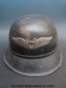 A Nazi German 'Luftschutz' helmet complete with registration number and original Kopfweite decal to