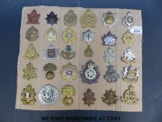 A collection of 30 WWII Canadian Army cap badges