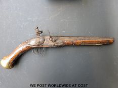 Flintlock hammer action holster pistol with engraved brass mounts,