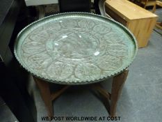 An exceptionally large Iraqi copper charger on wooden base (diameter 81cm)