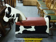 A mechanical playground rocking horse with ground spikes and fittings